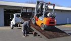 forklift on the back of a truck